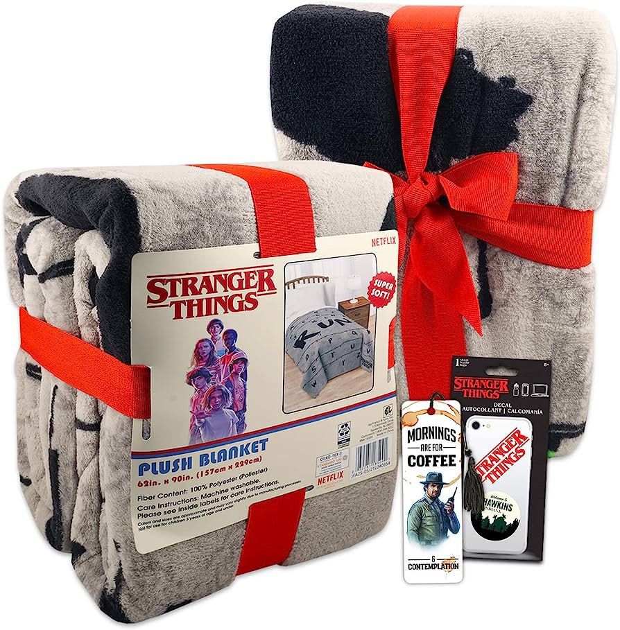 Grey plush blanket with letters tied with a red ribbon, plus a bookmark and phone decal
