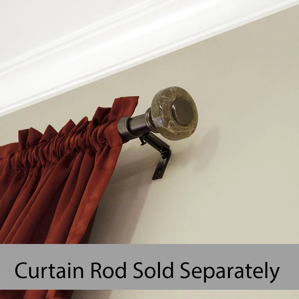 Marble-effect knob finial on a bronze rod holding a rust red curtain panel