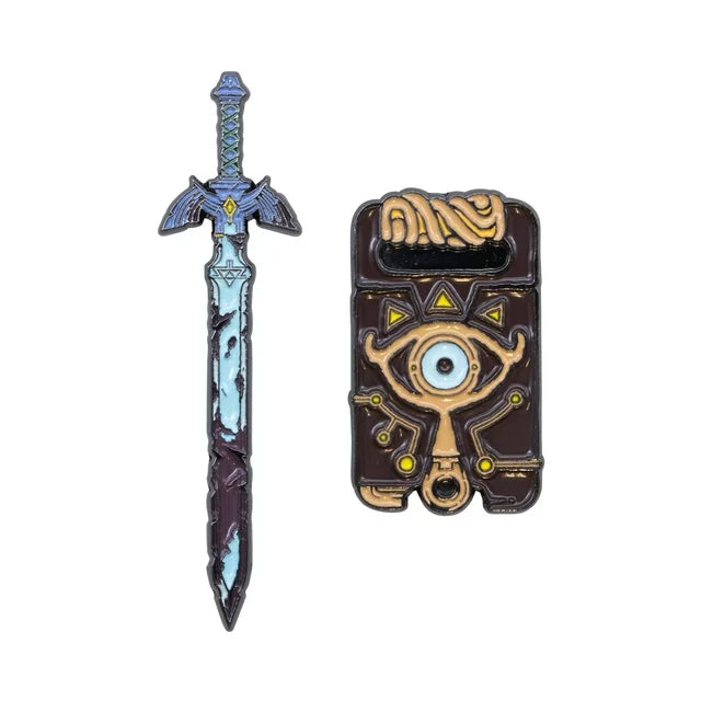 Two enamel pins: the Master Sword and the Sheikah Slate