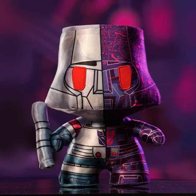 Megatron plush with arm cannon against a purple glowing background