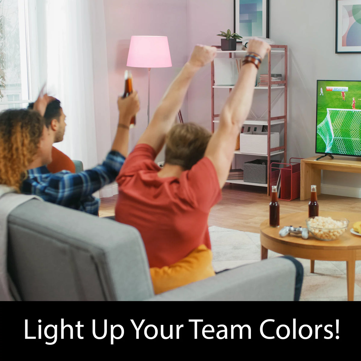 Friends cheering at a football game on TV under a pink floor lamp, Light Up Your Team Colors