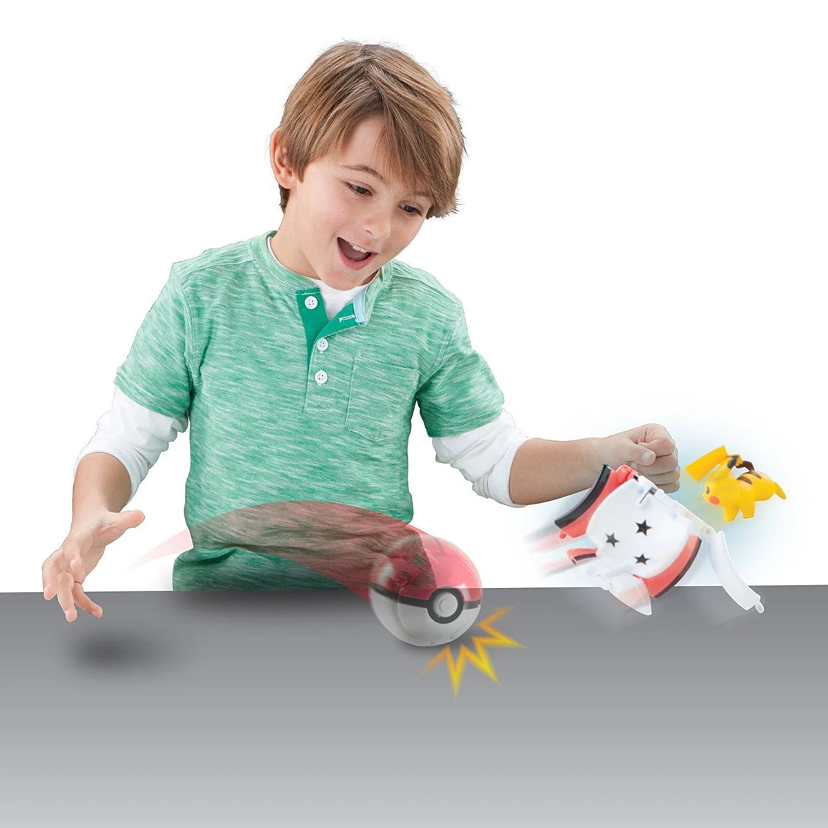 Excited boy throwing the capture ball onto a table as it pops open to release the yellow figure