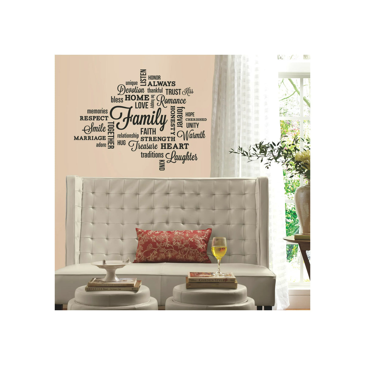 Family word cloud decals on a peach wall above a white tufted bench