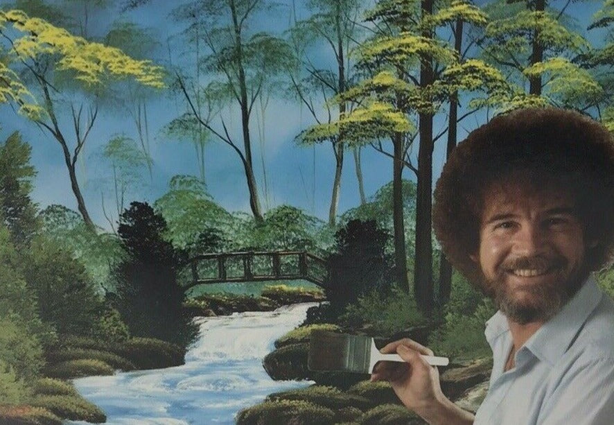 Bob Ross smiling with a brush beside his painting of a wooden bridge over a forest stream