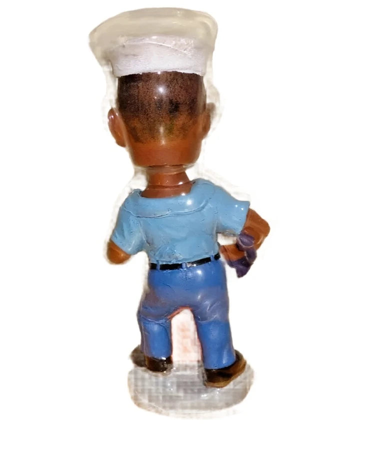 Back of the sailor bobblehead showing the white cap and blue shirt