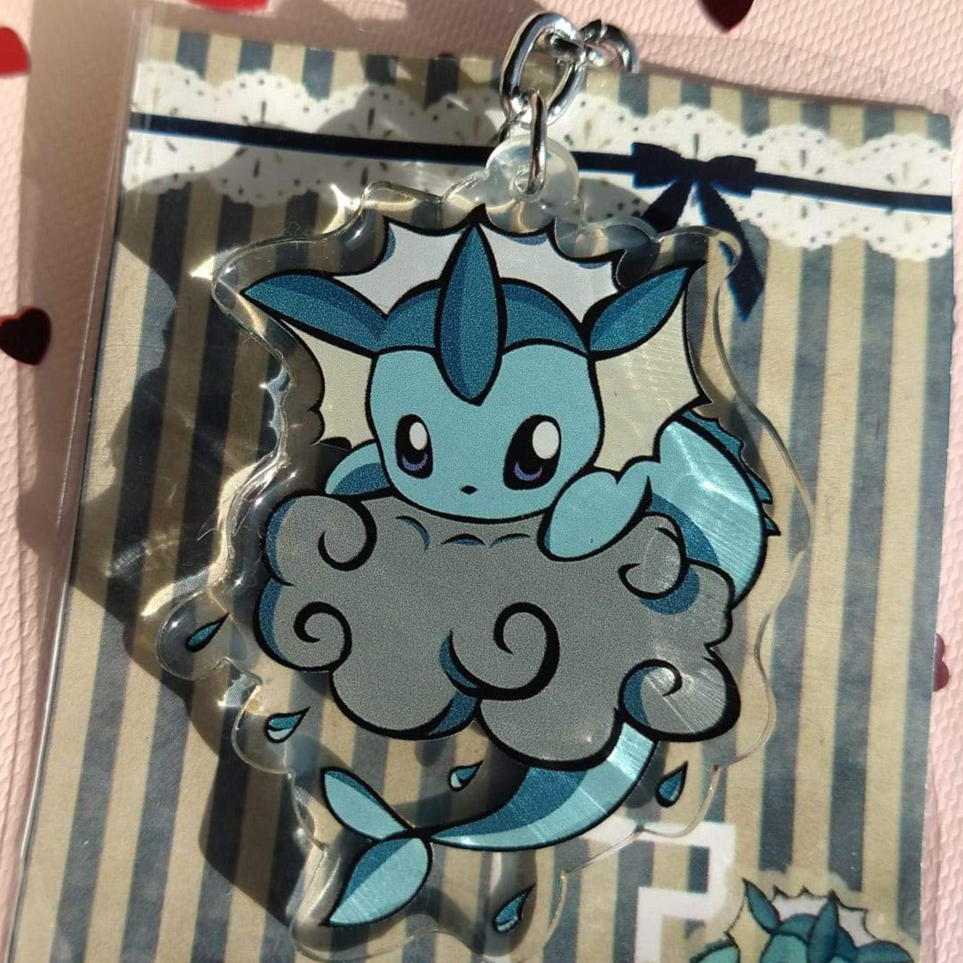 Acrylic Vaporeon keychain peeking over a grey swirl cloud with water droplets