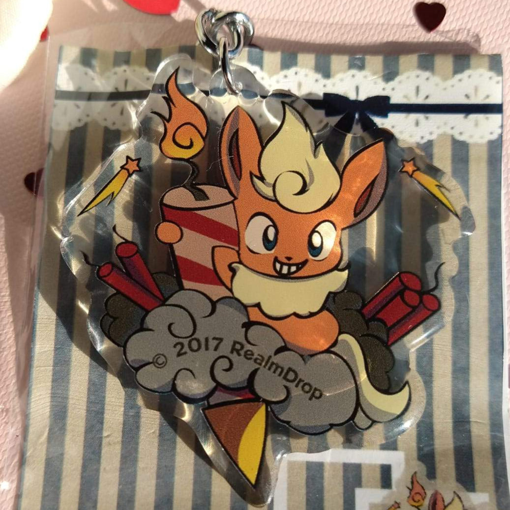 Grinning Flareon with a striped firework rocket and firecrackers acrylic keychain