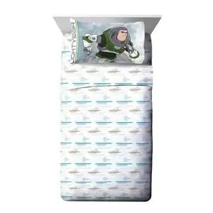 Twin bed with a Lightyear pillowcase and white sheets printed with spaceships