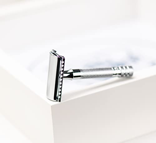 Chrome safety razor resting on the edge of a white box