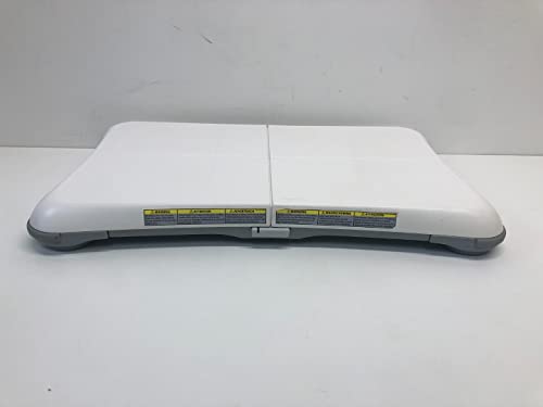 Front edge of the balance board with yellow caution labels and power button