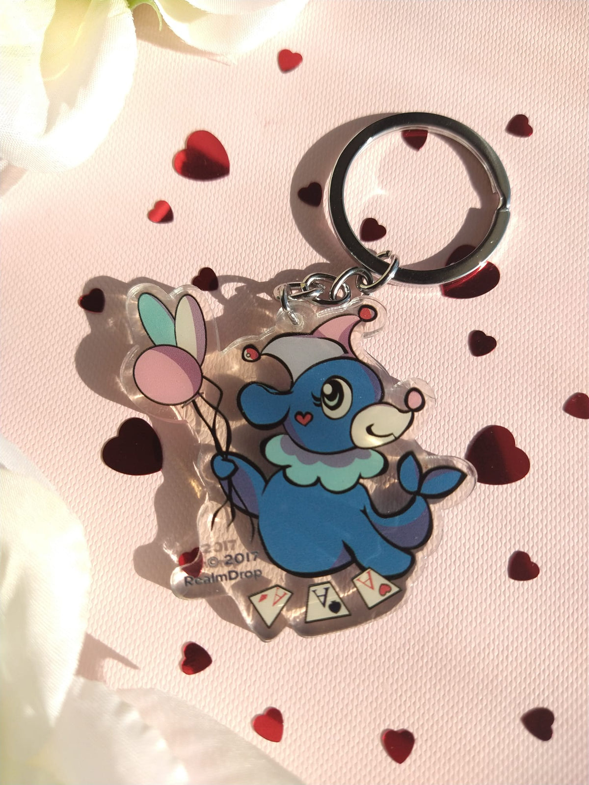 Acrylic Popplio keychain dressed as a clown with balloons and playing cards