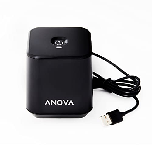 Black cube-shaped handheld vacuum sealer with a USB charging cable