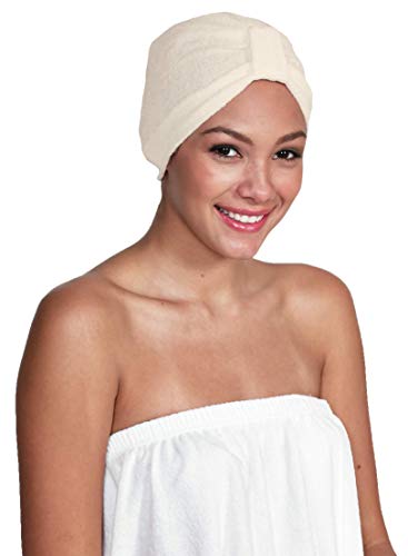 Smiling woman in a towel wrap wearing a cream terry turban