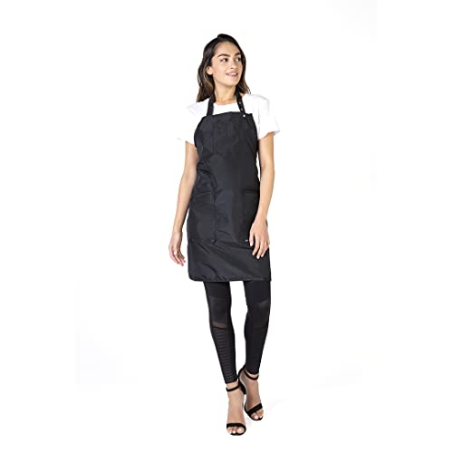 Woman standing in the black stylist apron, side angle