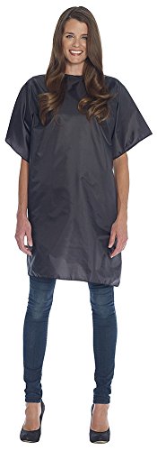 Woman wearing a short black salon styling cape over jeans
