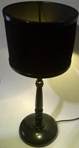 Black retro desk lamp with drum shade and round base on a table