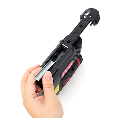 Hand loading a strip of staples into the open staple gun magazine
