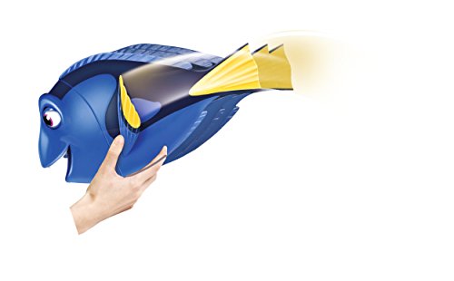 Hand holding the Dory toy from below with her tail fin in motion
