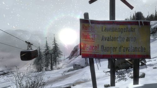 Avalanche danger sign in a snowstorm beside a cable car