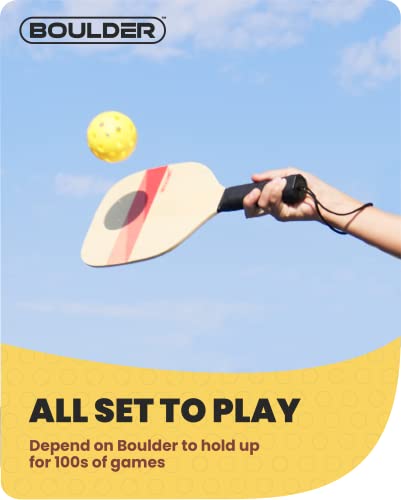 Hand swinging a wooden paddle at a yellow ball against a blue sky