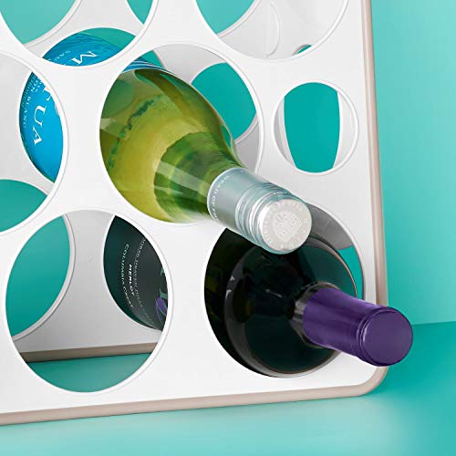 White bottle stand holding wine bottles on their sides against a teal wall