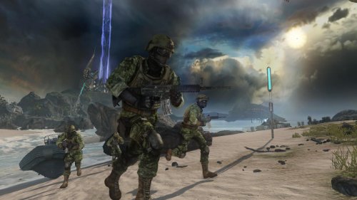 Soldiers in camo running up a beach under a stormy sky