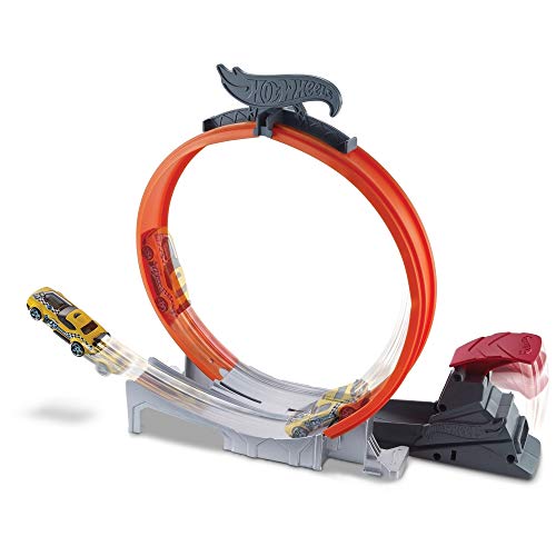 Yellow car racing around the orange Hot Wheels Loop Star loop from the launcher