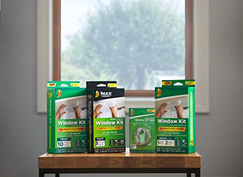 Range of window kit boxes and a tape pack on a wooden table by a window