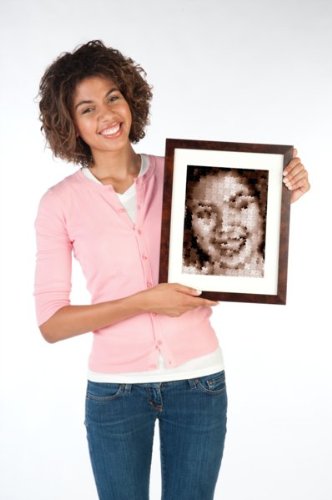 Smiling woman holding a framed sepia Ji Ga Zo puzzle portrait of herself