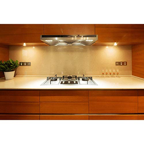 Kitchen with wood cabinets and a stovetop lit by warm recessed spotlights