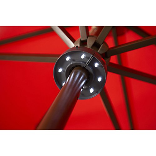 LED ring lit up under a red patio umbrella around its wooden pole
