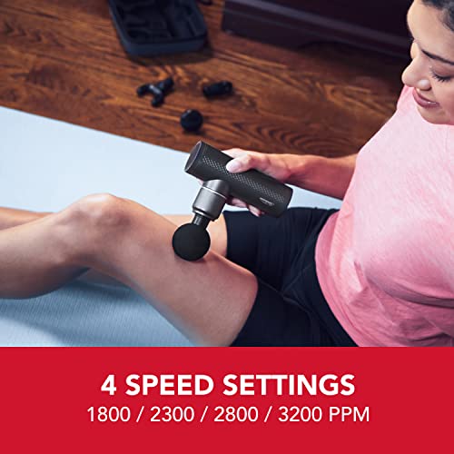 Woman massaging her thigh on a yoga mat: 4 speed settings