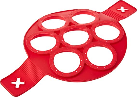 Angled view of the red seven-ring silicone pancake mould on white
