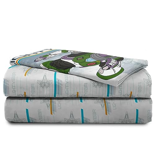 Folded grey Lightyear sheets with spaceships and a Buzz pillowcase on top