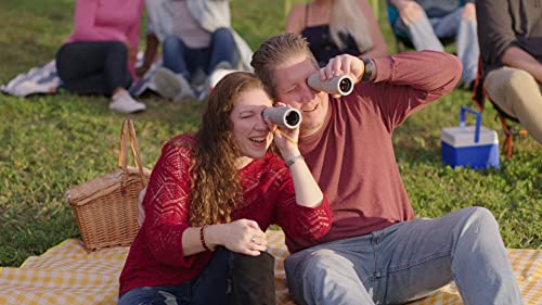 Couple on a picnic blanket each looking through a Bionic Zoom scope