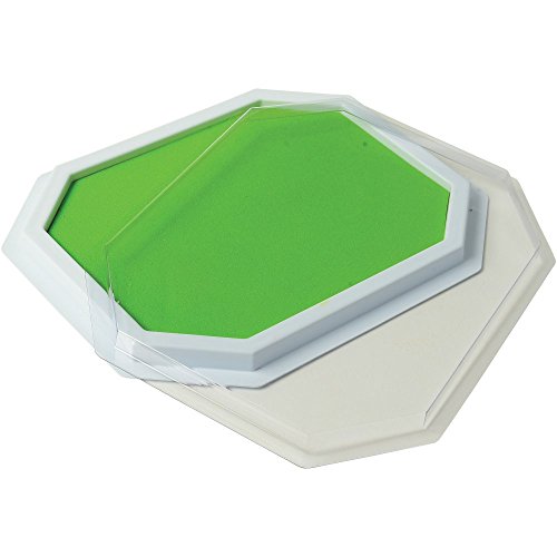 Green stamp pad with its clear lid lifted off the white base