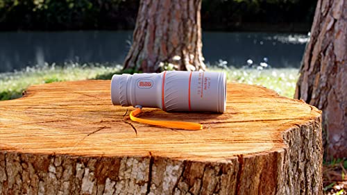 Grey Bionic Zoom scope with orange strap resting on a tree stump