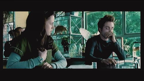 Film still of two students at a biology lab bench by a window