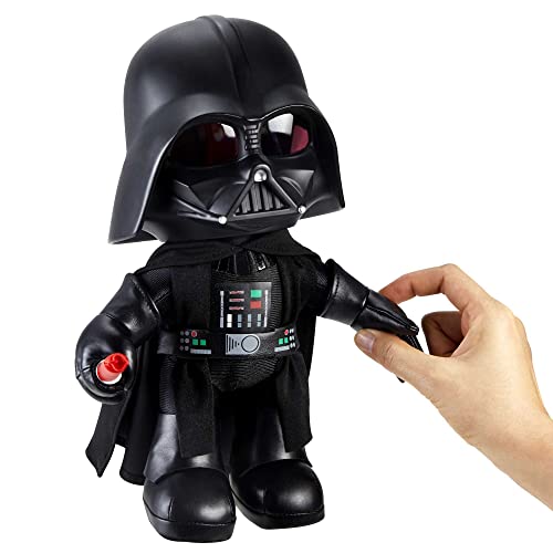 Hand pressing the arm of the Darth Vader plush to work its feature