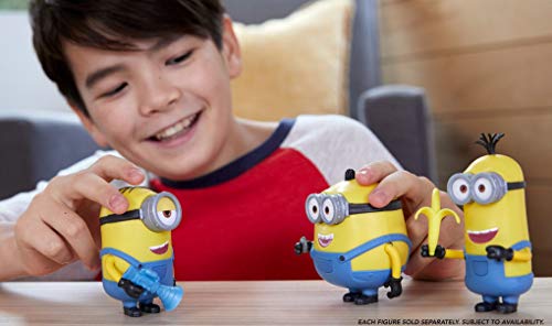 Boy playing with three Sing 'n Babble Minion figures on a table