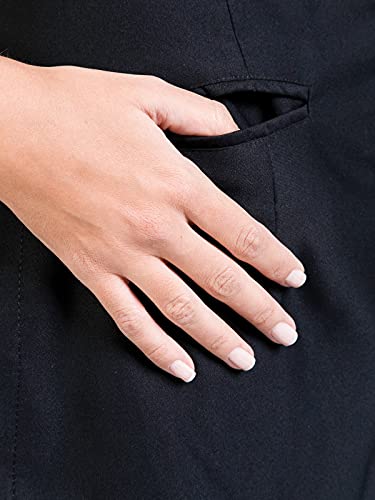 Hand slipped into the slit pocket of the black stylist jacket