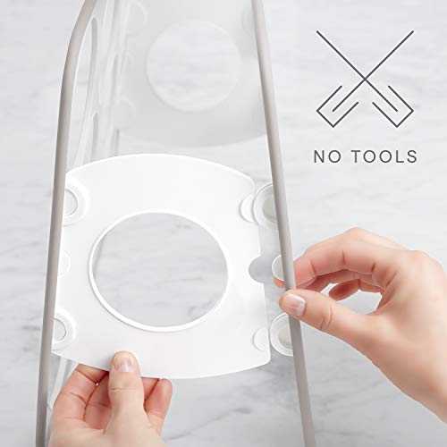 Hands snapping a white shelf panel into the bottle stand, no tools needed