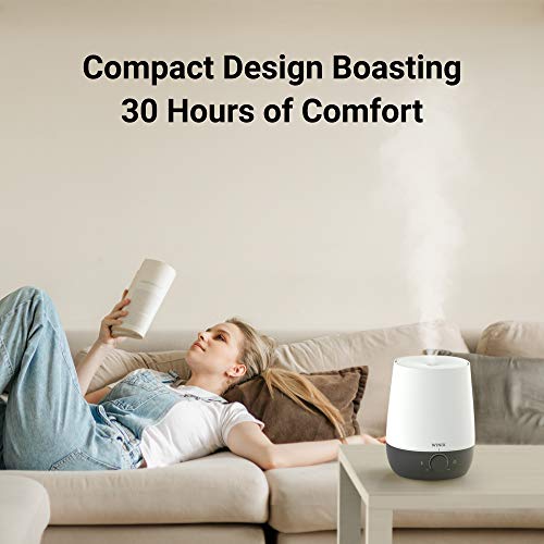 Humidifier misting on a side table beside a woman reading on a sofa