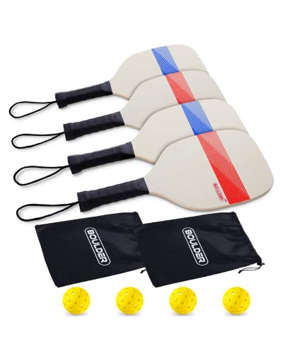 Four wooden pickleball paddles with red and blue stripes, two bags and four yellow balls