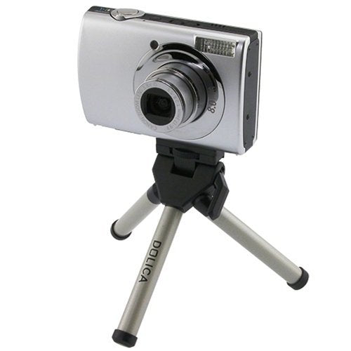 Silver compact camera mounted on the Dolica mini tripod