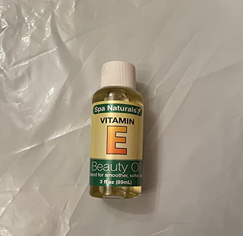 Small clear bottle of vitamin E beauty oil with a green and yellow label, 3 fl oz