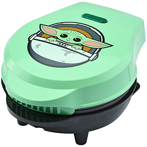 Mint green mini waffle maker with Grogu in his pod on the lid