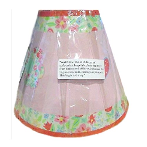 Pink nursery lamp shade with floral trim and flower patches, still in plastic wrap