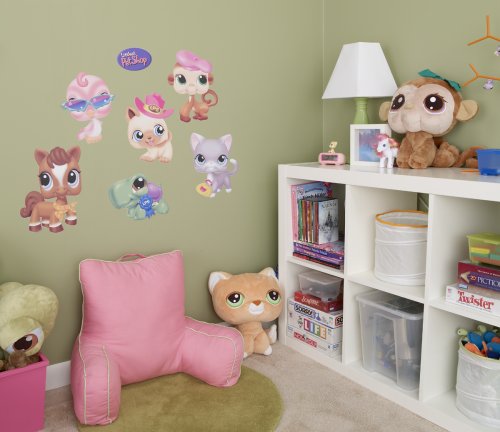 Kids' room with Littlest Pet Shop wall decals, a pink chair, plush toys and shelves