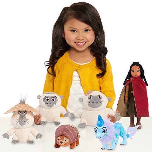 Smiling girl with the Raya and the Last Dragon plush collection including Tuk Tuk